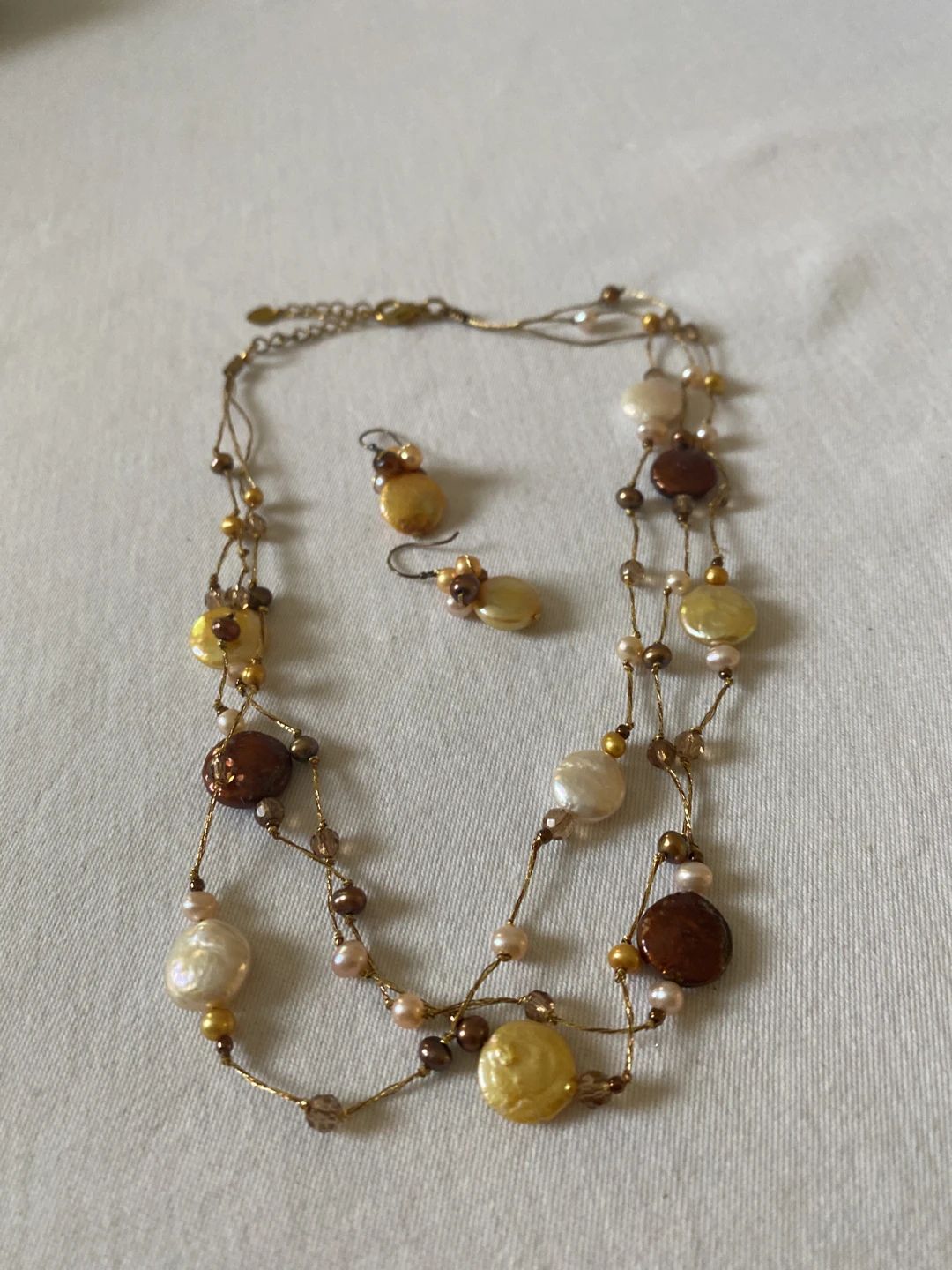 Multi-strand necklace with iridescent coin pearls and matching earrings