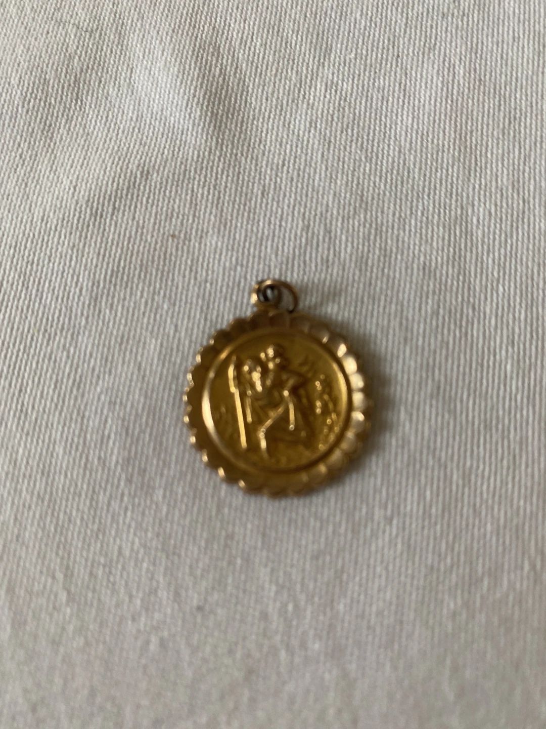 Vintage gold-toned St. Christopher medal pendant with scalloped edge